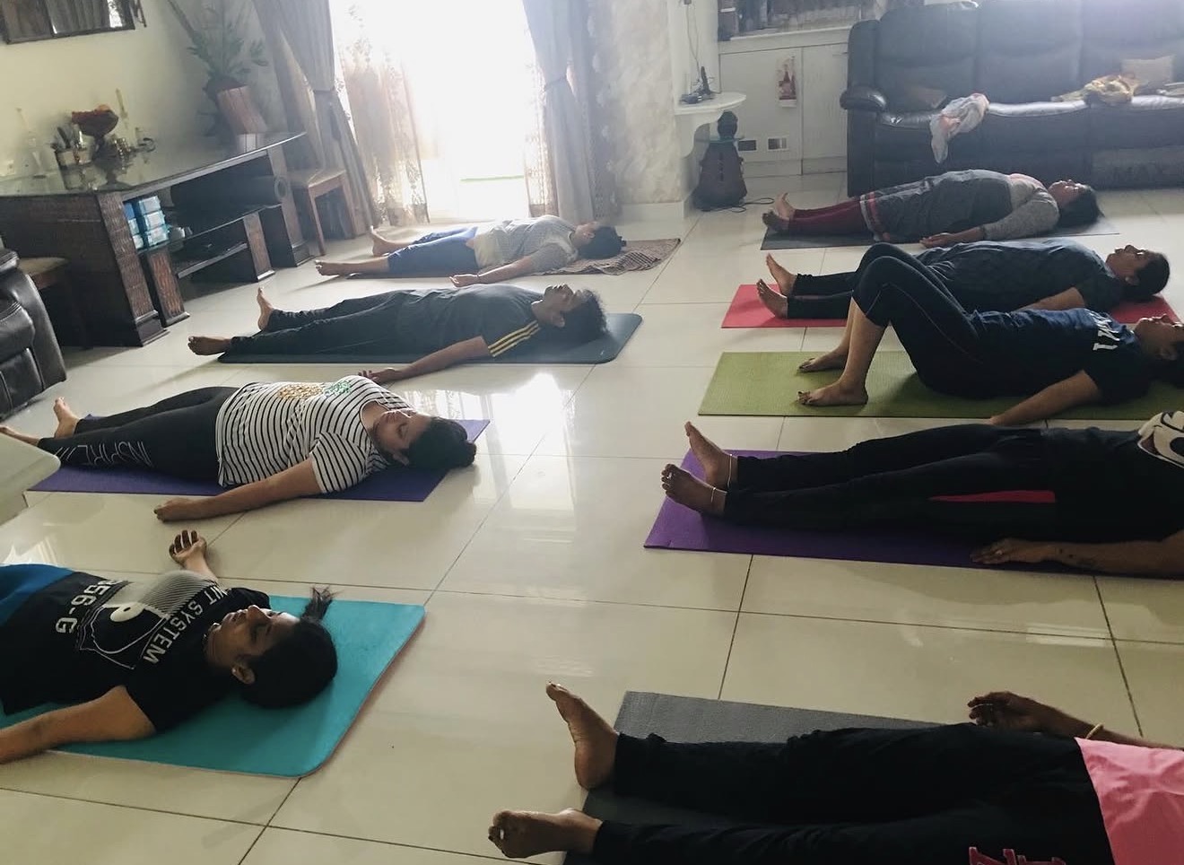 A group of women resting in a guided Yoga Nidra session